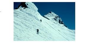 traversing the snow ridge to the summit pinnacle